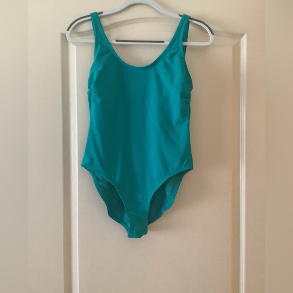 Xhileration one piece green size Med rounded back fits good.